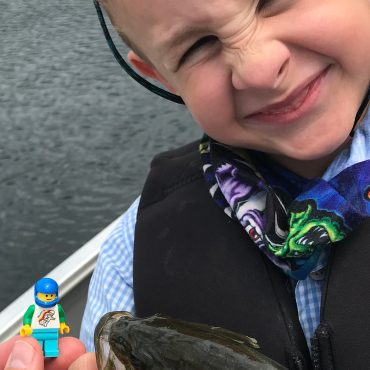 Child Posing With Fish