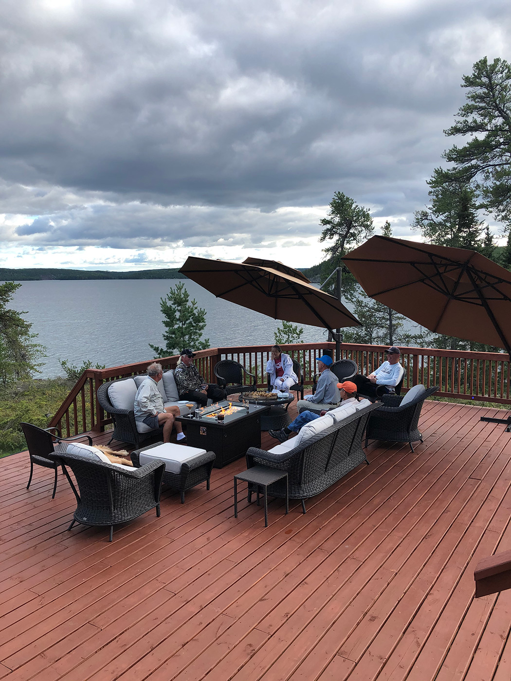 Guests On Porch By The Lake